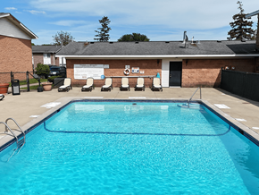 Rochester townhouse for rent - A swimming pool in front of a building with a white signboard.
