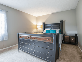 Omaha townhouse for rent - a bedroom with a bed and a dresser