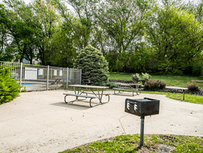 Omaha townhouse for rent - a picnic table with a grill on apartment property