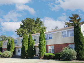 Rantoul townhouse for rent - A row of houses with trees in front.