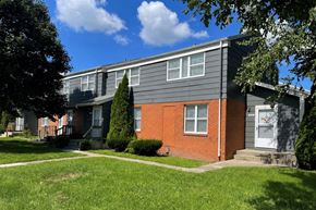 Rantoul townhouse for rent - A house with a grey roof and a red brick wall.