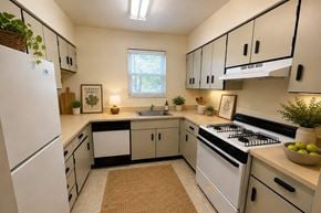Rantoul townhouse for rent - A kitchen with white appliances and black handles.