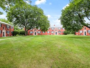 Toledo apartment for rent - a large green lawn in front of brick apartment building