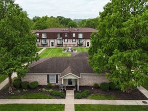 New Albany apartment for rent - A building with a brown roof is surrounded by trees.