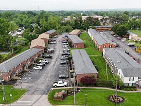 Clarksville apartment for rent - A parking lot in front of a building with a grassy area.