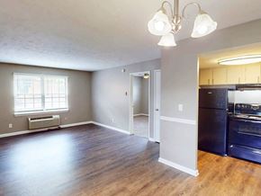 Clarksville apartment for rent - Kitchen with black appliances and open living room