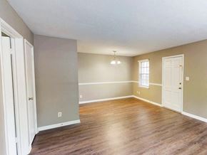 Clarksville apartment for rent - A room with wooden floors and white doors.