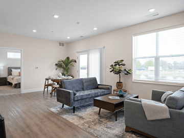 Muskegon apartment for rent - A living room with a grey couch and a coffee table.
