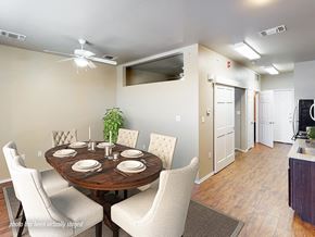 Lubbock apartment for rent - A dining room with a round table set for six.