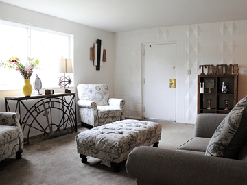 St. Ann apartment for rent - a living room with couches and chairs and a