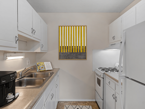 St. Joseph apartment for rent - a kitchen with white cabinets and white appliances