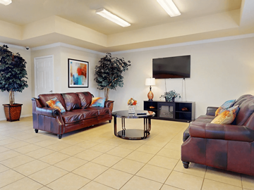 Abilene apartment for rent - A living room with a brown leather couch and a coffee table.