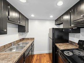 West Chester apartment for rent - a kitchen with black appliances and granite counter tops