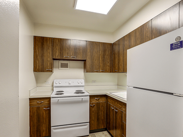 Lansing apartment for rent - A kitchen with a white stove and refrigerator.