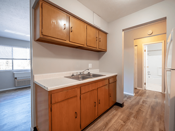 Parkersburg apartment for rent - A kitchen with wooden cabinets and a white countertop.