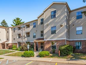 Haslett apartment for rent - Apartment building with a parking lot in front.