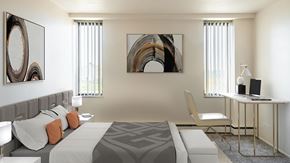 Lansing apartment for rent - A modern bedroom with a large bed and two art pieces on the wall.