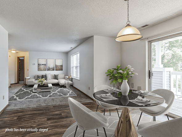Coon Rapids apartment for rent - A modern living room with a glass table and white chairs.
