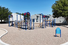 Pueblo apartment for rent - A playground with a blue sign that says