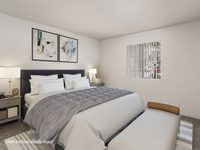 Albuquerque apartment for rent - A bedroom with a large bed and two framed artworks on the wall.