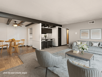 Albuquerque apartment for rent - A living room with a grey carpet and a grey couch.