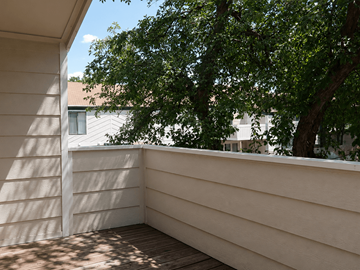 Aurora townhouse for rent - A balcony with a wooden floor and a white wall.
