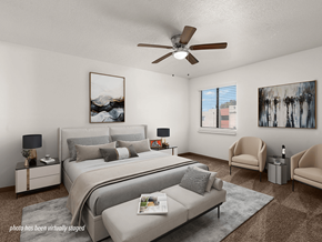 Albuquerque apartment for rent - A bedroom with a large bed, a couch, and a ceiling fan.