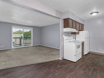 Wichita apartment for rent - A kitchen area with a white fridge and stove top oven.