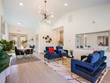 Fayetteville apartment for rent - a living room with blue furniture and a chandelier
