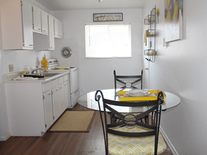 St. Louis apartment for rent - a small kitchen with a table and chairs and a sink