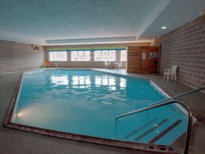 Marquette apartment for rent - A small indoor swimming pool with a metal ladder.