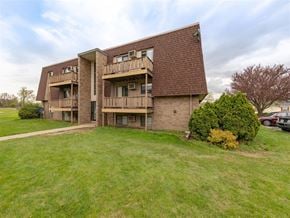 Sandusky apartment for rent - A large apartment building with a grassy lawn in front.