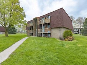 Sandusky apartment for rent - A grassy area in front of a building with a red roof.