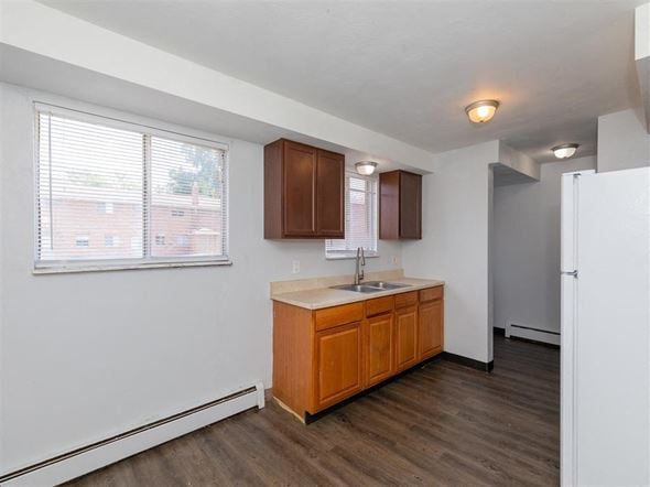 Sandusky apartment for rent - A kitchen with wooden cabinets and a white fridge.