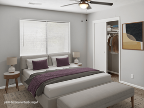Omaha apartment for rent - A bedroom with a bed, nightstands, and a ceiling fan.