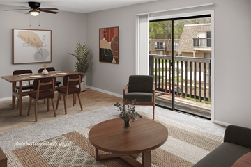 Omaha apartment for rent - A living room with a dining table and chairs, a ceiling fan, and a view of a balcony with a railing.