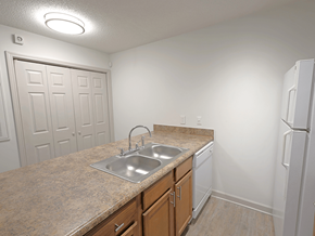 Fayetteville apartment for rent - A kitchen with a sink and a refrigerator.