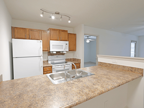 Fayetteville apartment for rent - A kitchen with granite countertops and white appliances.