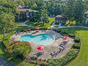 Keego Harbor apartment for rent - an aerial view of a swimming pool and patio with umbrellas