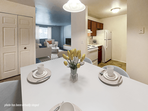 Keego Harbor apartment for rent - A dining room with a table set for two and a kitchen in the background.