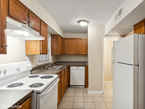 Louisville apartment for rent - apartment kitchen with white appliances and wooden cabinets