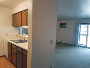 Rapid City apartment for rent - A kitchen with brown cabinets and a white sink.