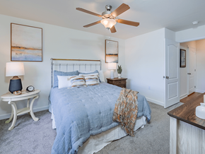 Fayetteville apartment for rent - A bedroom with a bed, a fan, and a nightstand.