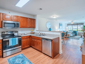 Fayetteville apartment for rent - A kitchen with wooden cabinets and stainless steel appliances.