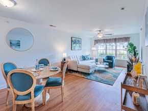 Fayetteville apartment for rent - A dining room with blue chairs and a white couch.