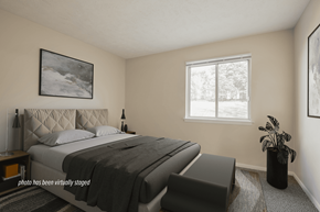 Omaha apartment for rent - A bedroom with a large bed and a window.