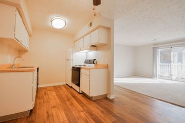 Omaha apartment for rent - A kitchen with white cabinets and wooden floors.