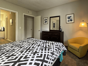 West Columbia apartment for rent - a bedroom with a large bed and a yellow chair