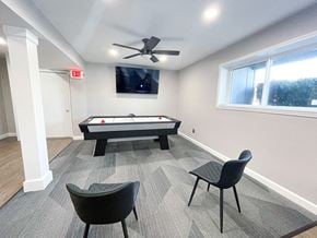 Davison apartment for rent - a game room with an air hockey table and a flat screen tv