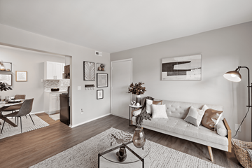 Grand Blanc Twp apartment for rent - A living room with a white couch and a coffee table.